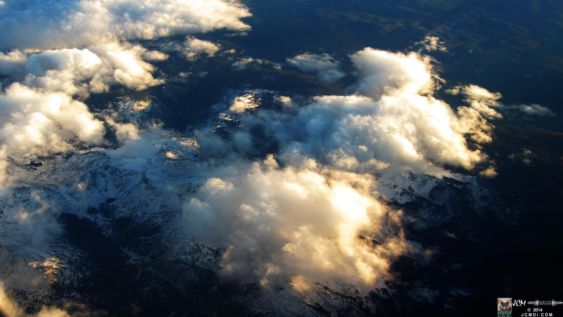MSP-LAX mountain terrain sunset snowy peaks and cumulus from airline window